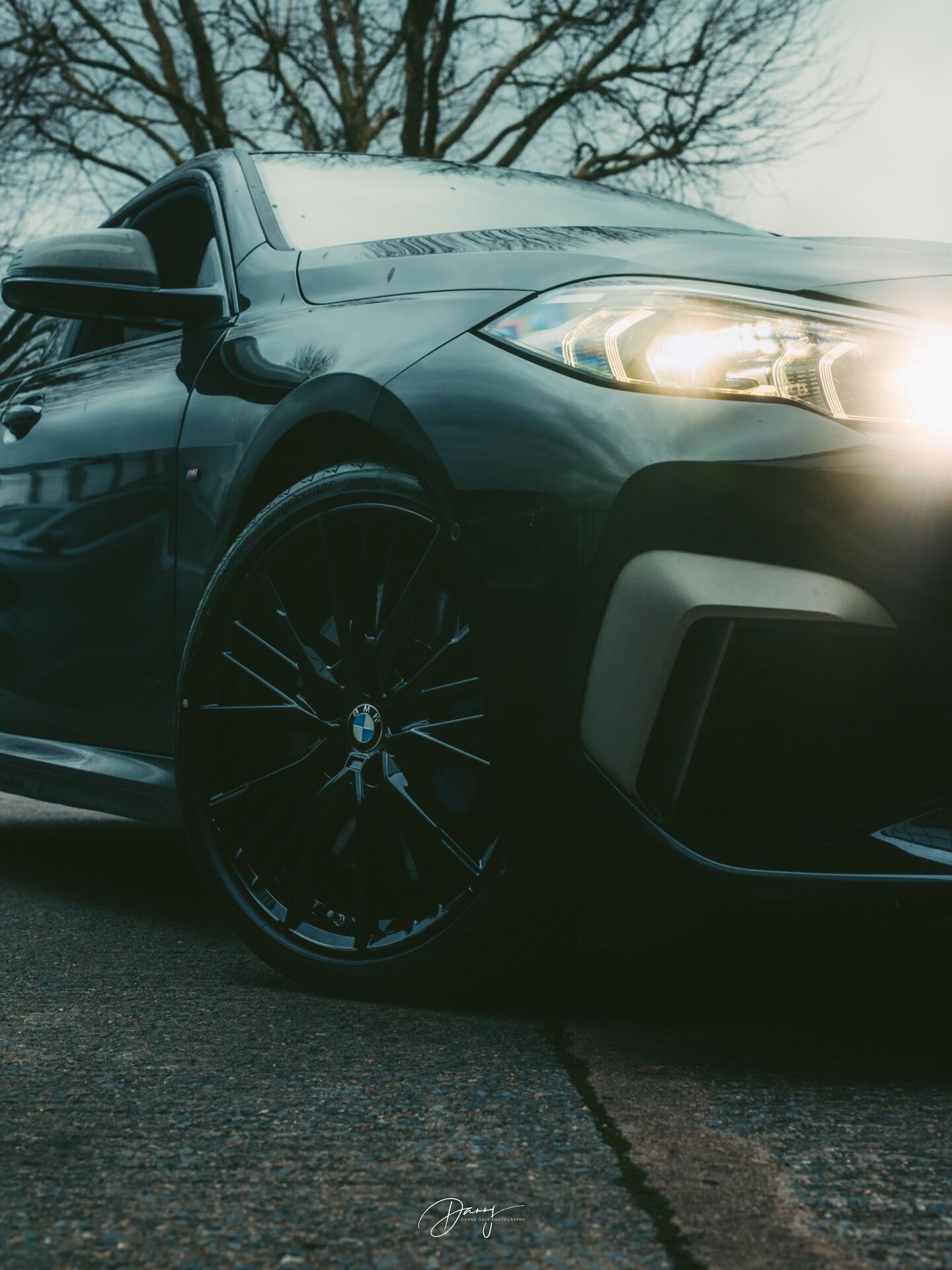 BMW headlight flare with refurbished wheel visible