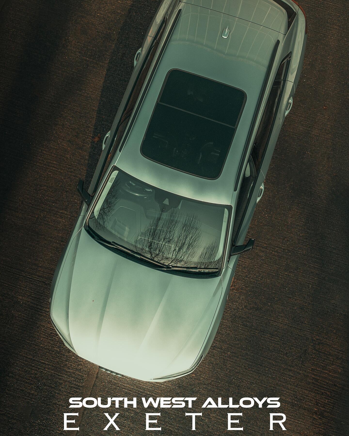 Silver Porsche Cayenne aerial view with refurbished wheels