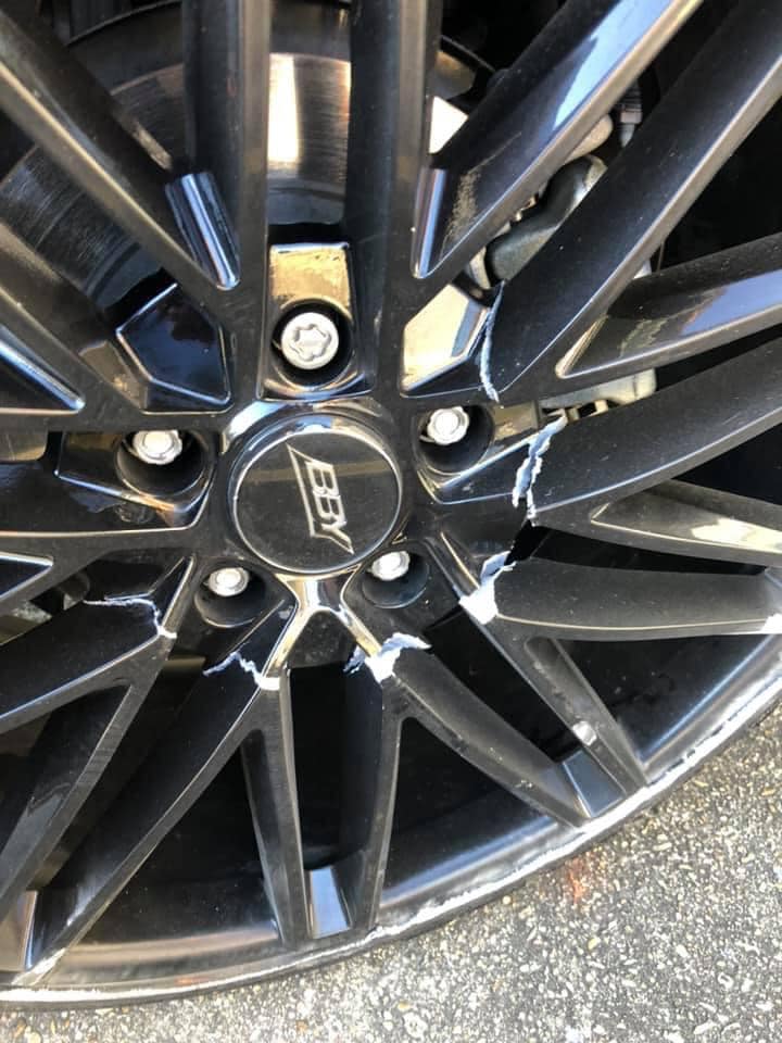 Kerb rash damage on alloy wheel before professional repair