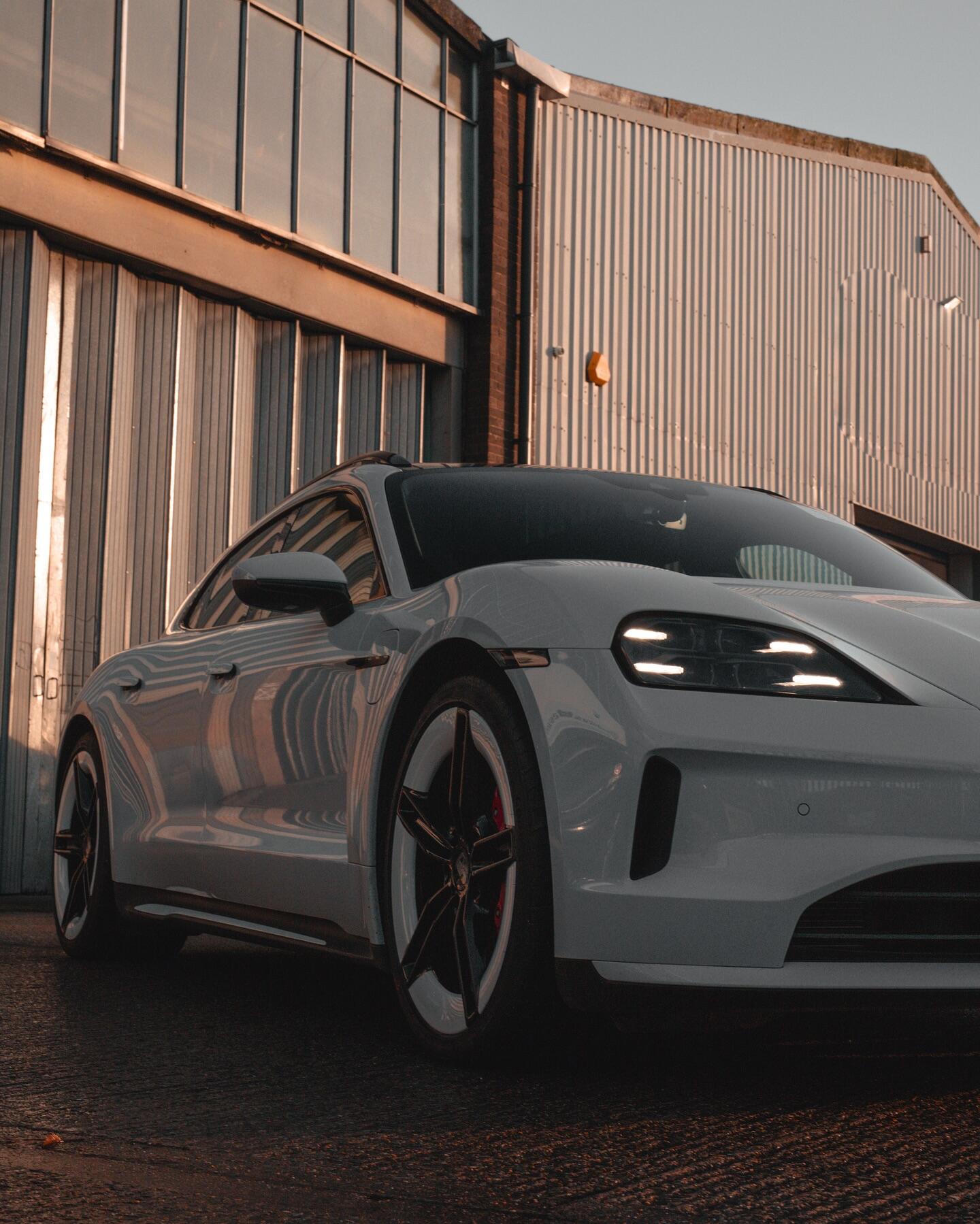 Porsche Taycan grey front view with refurbished alloy wheels