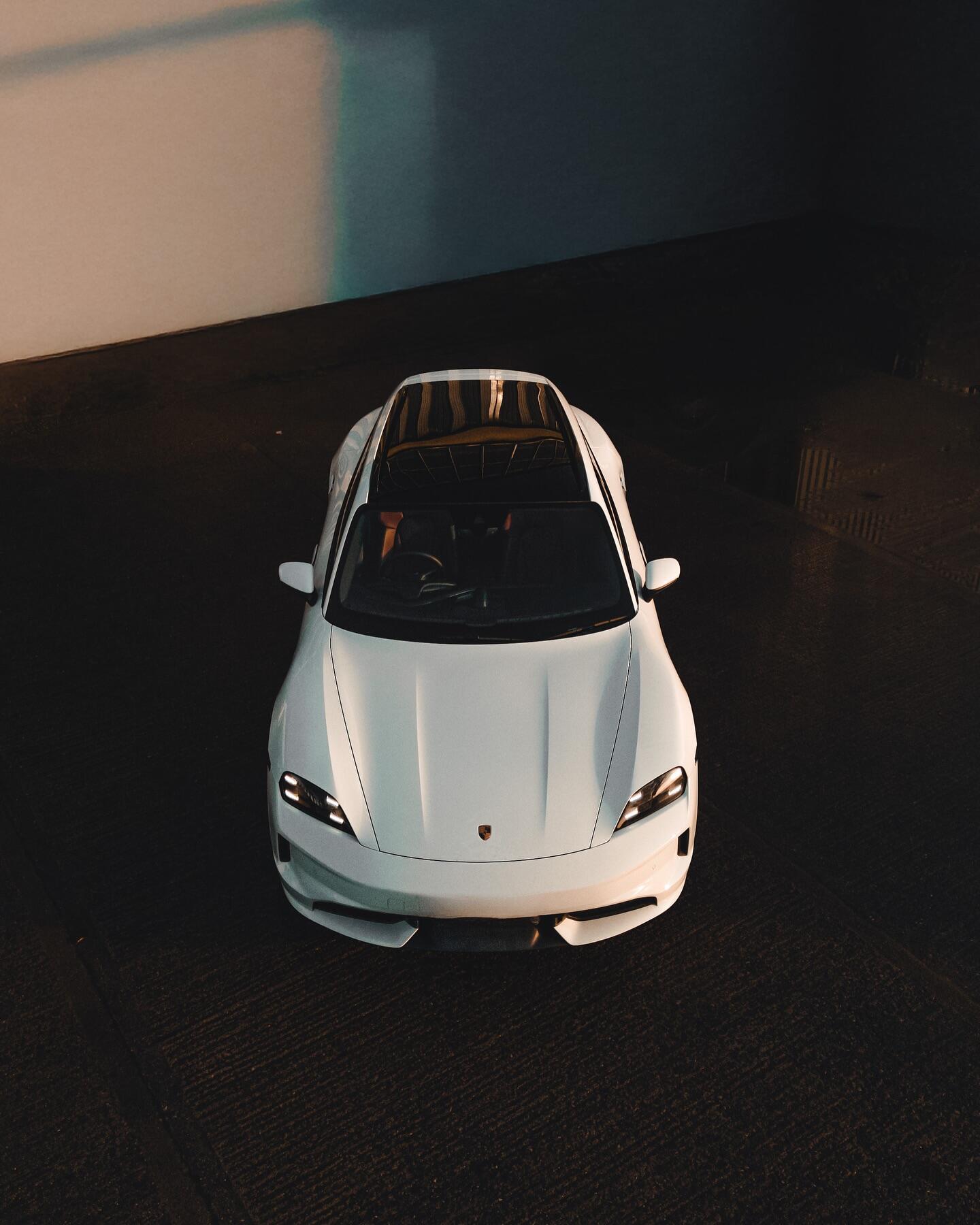 White Porsche Taycan front aerial view