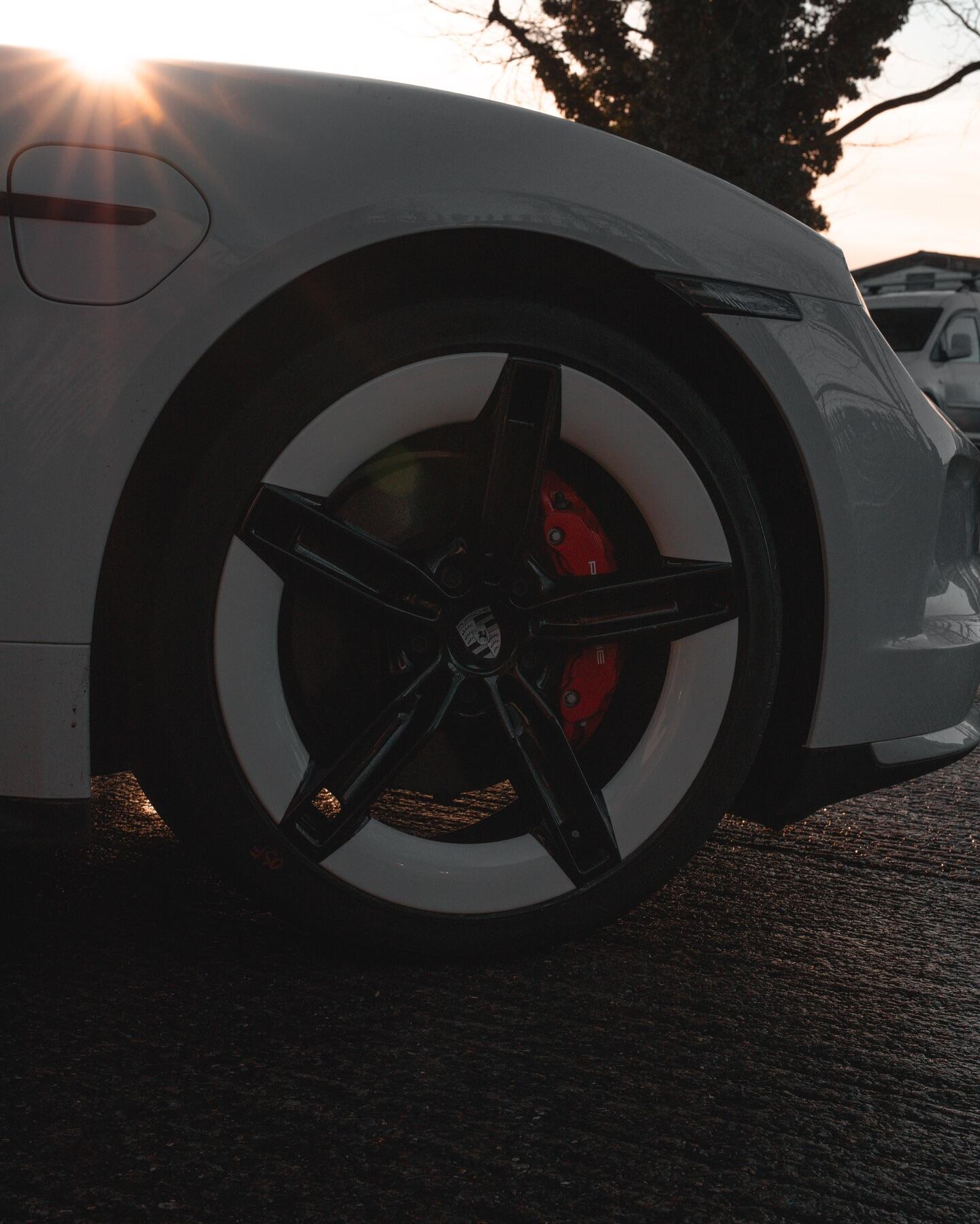 Porsche Taycan white wheel at sunset