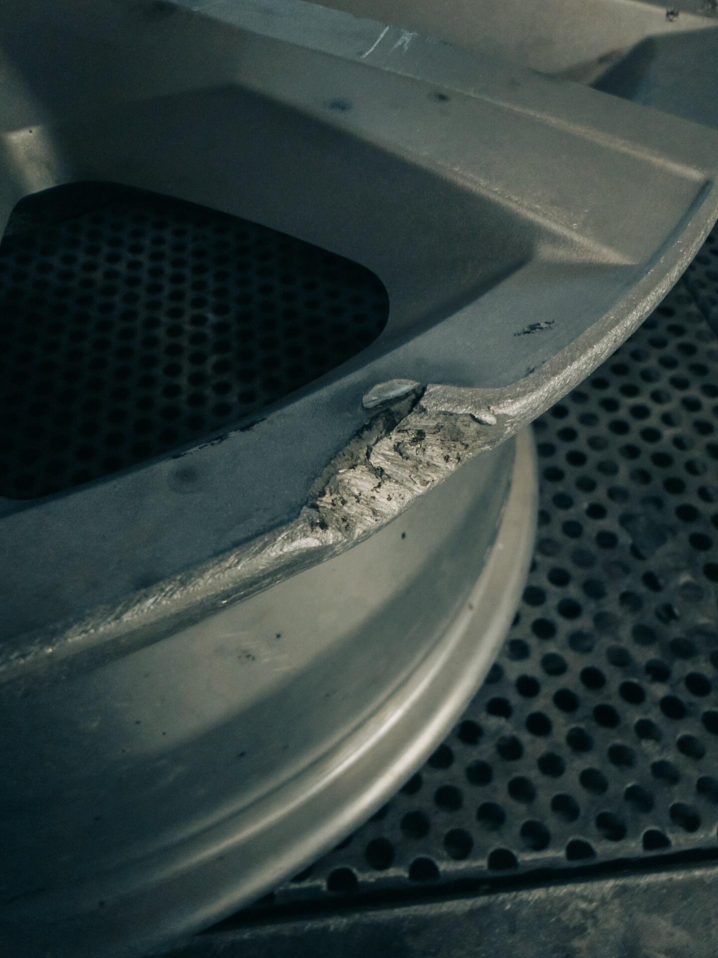 Alloy wheel damage close-up showing impact marks