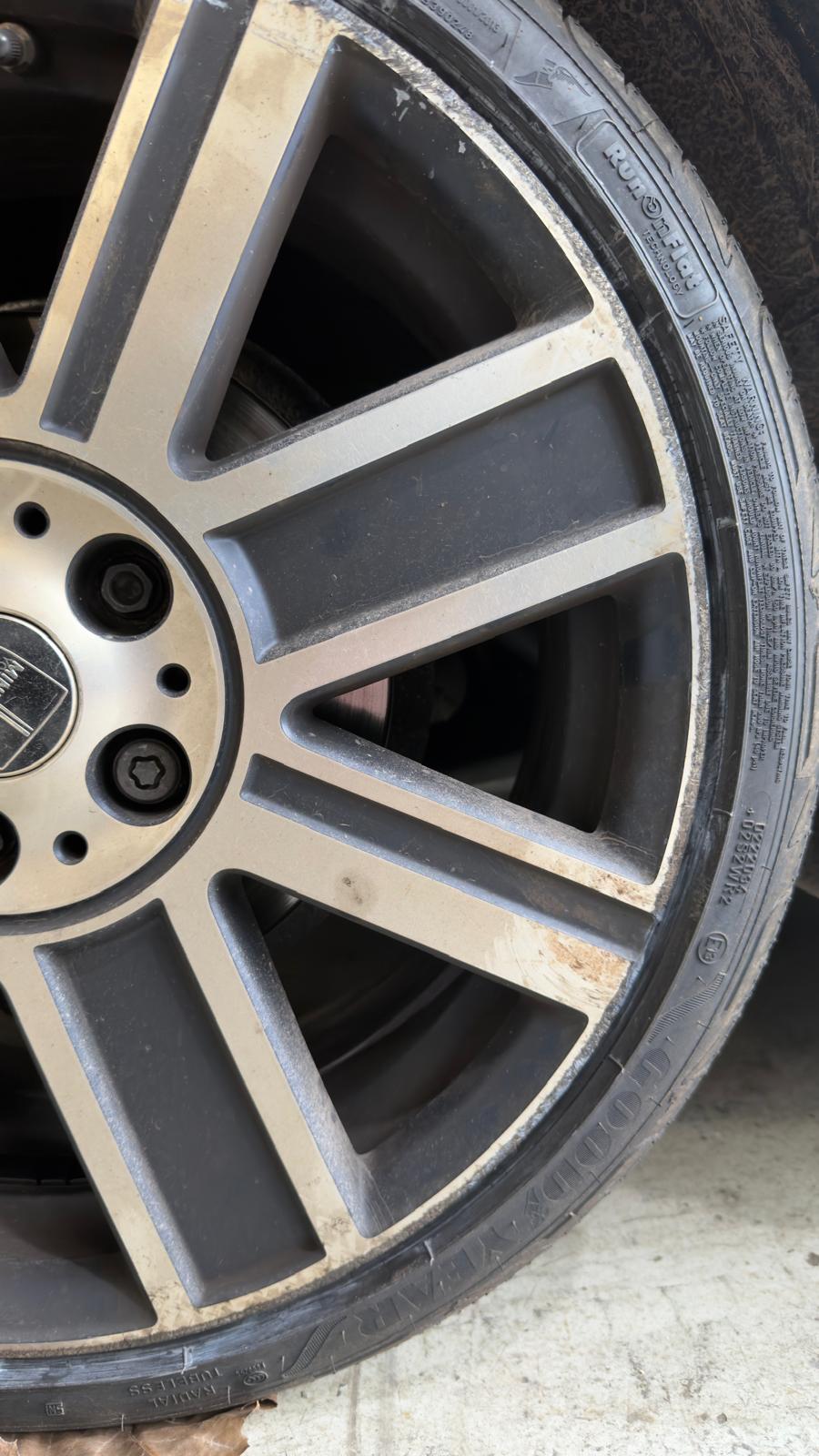 Kerb rash damage on alloy wheel before professional repair